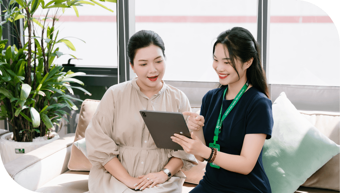 Two women discussing health plans on a tablet