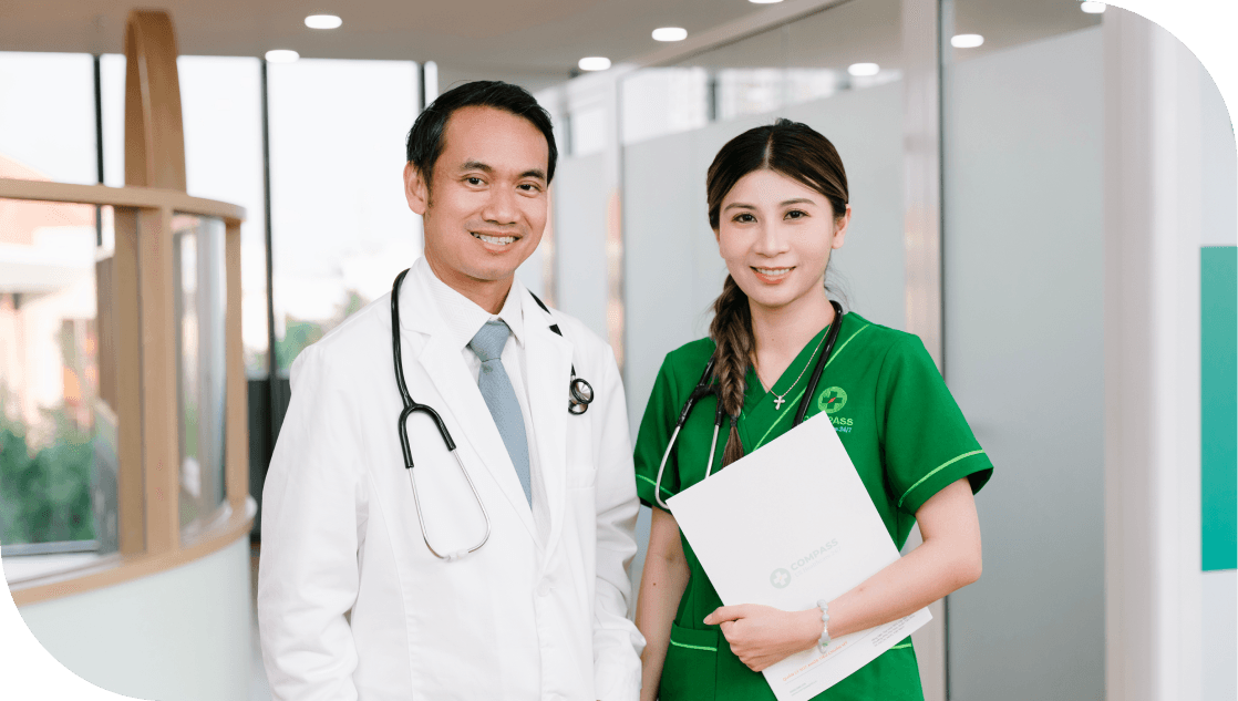 Two healthcare professionals smiling at the camera